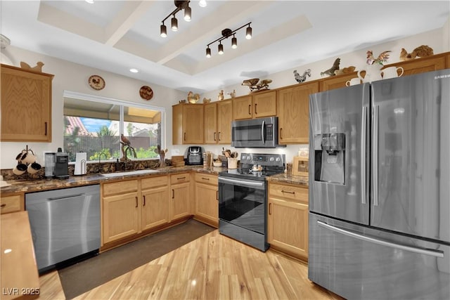 9237 Quail Ridge Dr, Las Vegas, NV 89134 - kitchen featuring appliances with stainless steel finishes, wood finished floors, a raised ceiling, rail lighting, and dark stone countertops