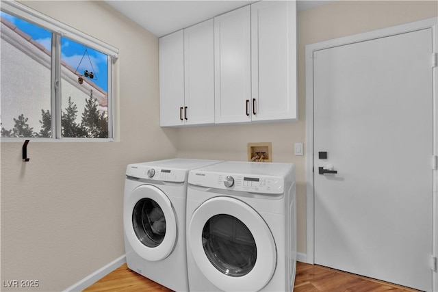 9237 Quail Ridge Dr, Las Vegas, NV 89134 - laundry area with cabinet space, washing machine and clothes dryer, and light wood-type flooring