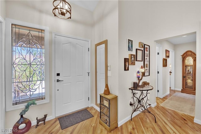 9237 Quail Ridge Dr, Las Vegas, NV 89134 - entrance foyer featuring light wood-style floors, a towering ceiling, and a chandelier