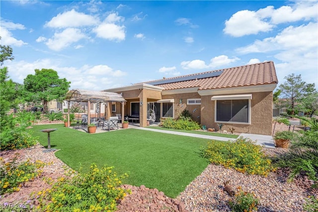 9237 Quail Ridge Dr, Las Vegas, NV 89134 - rear view of property with solar panels, stucco siding, a tiled roof, a lawn, and a patio area