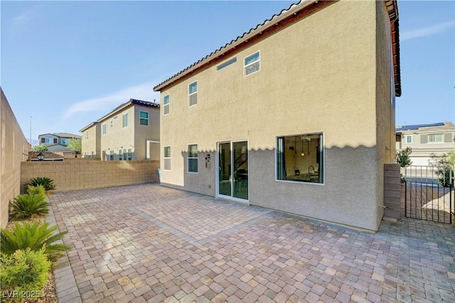 4641 Therapeutic St, North Las Vegas, NV 89031 - rear view of property with a fenced backyard, stucco siding, a patio, and a residential view