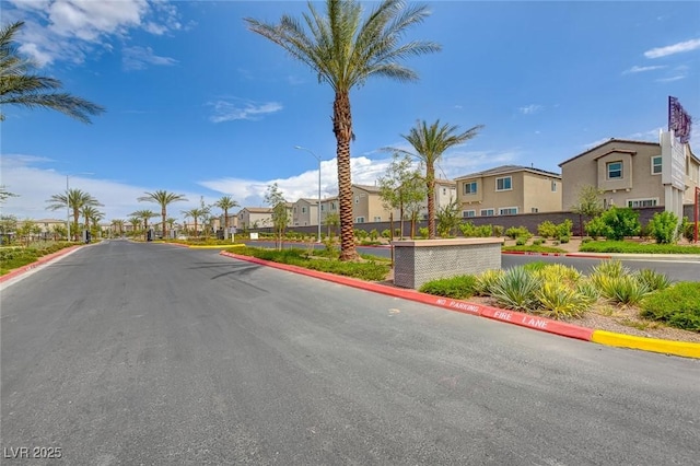 4641 Therapeutic St, North Las Vegas, NV 89031 - view of asphalt road featuring a residential view, street lights, and curbs