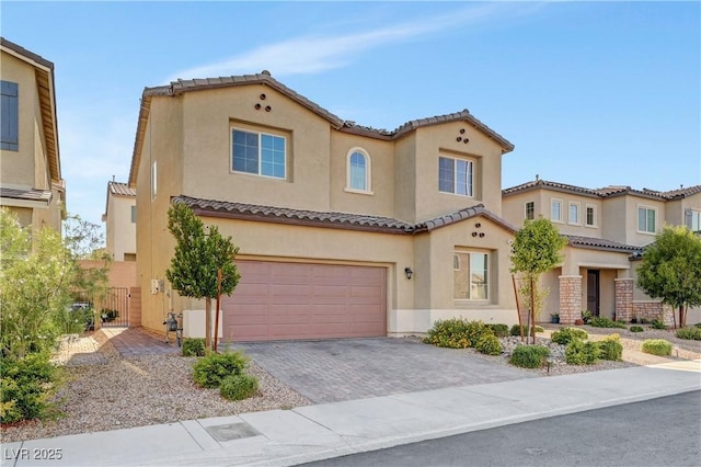 4641 Therapeutic St, North Las Vegas, NV 89031 - mediterranean / spanish-style house featuring stucco siding, a tile roof, a garage, and driveway