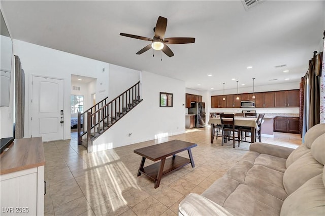 4641 Therapeutic St, North Las Vegas, NV 89031 - living area with a ceiling fan, light tile patterned flooring, stairs, and recessed lighting
