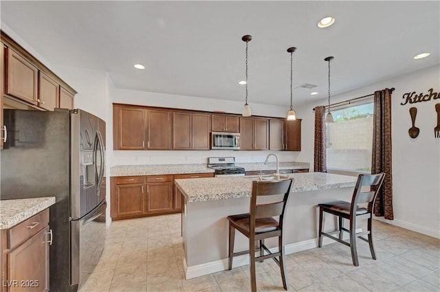 4641 Therapeutic St, North Las Vegas, NV 89031 - kitchen featuring stainless steel appliances, a breakfast bar, recessed lighting, a kitchen island with sink, and hanging light fixtures