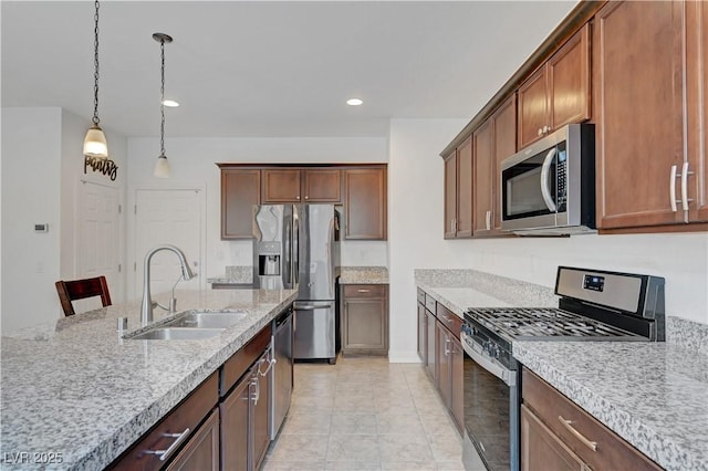 4641 Therapeutic St, North Las Vegas, NV 89031 - kitchen featuring appliances with stainless steel finishes, pendant lighting, light stone countertops, recessed lighting, and light tile patterned flooring