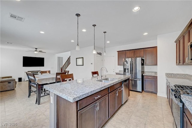 4641 Therapeutic St, North Las Vegas, NV 89031 - kitchen featuring appliances with stainless steel finishes, a ceiling fan, recessed lighting, an island with sink, and open floor plan