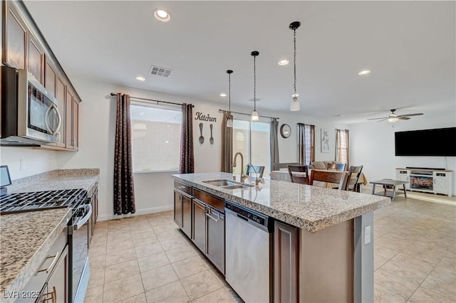 4641 Therapeutic St, North Las Vegas, NV 89031 - kitchen featuring appliances with stainless steel finishes, a ceiling fan, recessed lighting, a center island with sink, and open floor plan