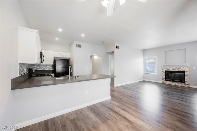 6006 Vegas Dr, Las Vegas, NV 89108 - kitchen featuring freestanding refrigerator, a peninsula, arched walkways, range, and ceiling fan