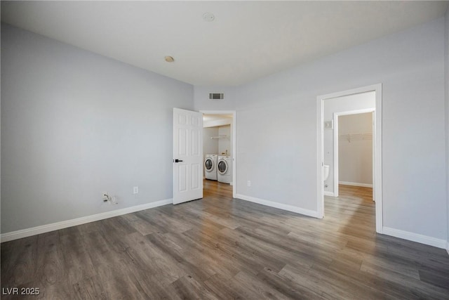 6006 Vegas Dr, Las Vegas, NV 89108 - unfurnished bedroom with wood finished floors, washing machine and dryer, and a spacious closet