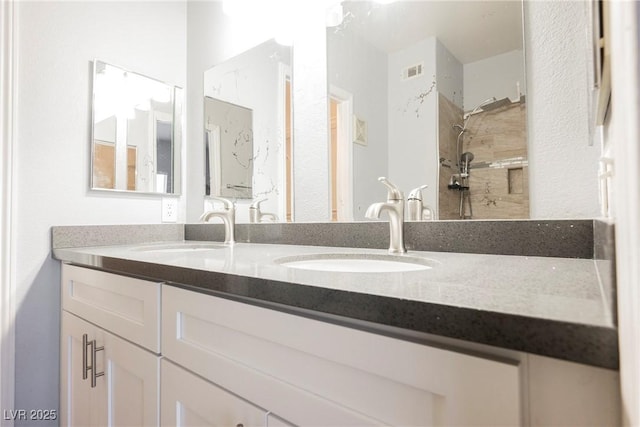 6006 Vegas Dr, Las Vegas, NV 89108 - bathroom featuring double vanity and a tile shower