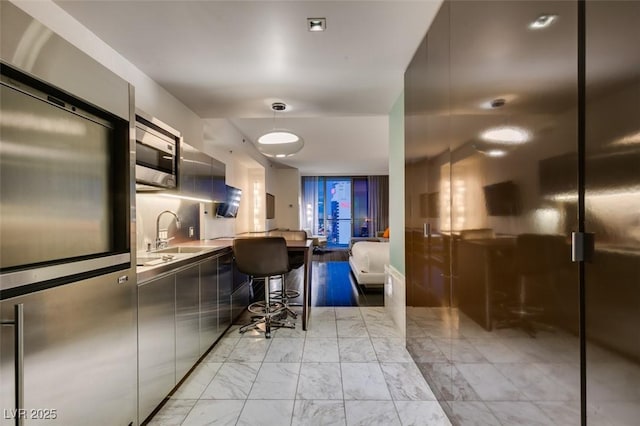 4381 Flamingo Rd Unit 2010, Las Vegas, NV 89103 - kitchen with stainless steel appliances, modern cabinets, light marble finish floors, and elevator