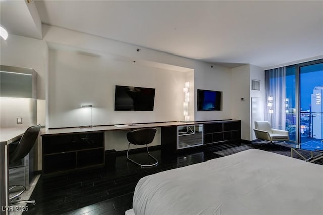 4381 Flamingo Rd Unit 2010, Las Vegas, NV 89103 - bedroom featuring expansive windows, wood finished floors, and a desk