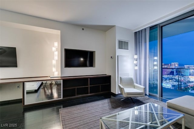 4381 Flamingo Rd Unit 2010, Las Vegas, NV 89103 - living room featuring expansive windows and wood finished floors