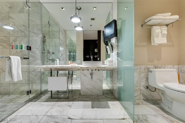 4381 Flamingo Rd Unit 2010, Las Vegas, NV 89103 - bathroom with a shower stall, marble finish floors, and tile walls