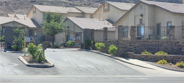 2050 N Los Feliz St Unit 170, Las Vegas, NV 89156 - view of asphalt street with curbs, a mountain view, and a gate