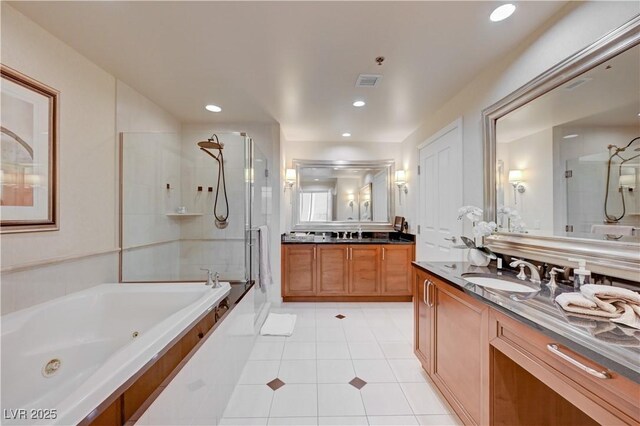 135 E Harmon Ave Unit 2721, Las Vegas, NV 89109 - full bath featuring a stall shower, tile patterned flooring, a jetted tub, two vanities, and recessed lighting