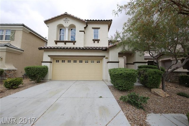 144 Lions Den Ave, North Las Vegas, NV 89031 - mediterranean / spanish home featuring stucco siding, concrete driveway, a garage, and a tiled roof