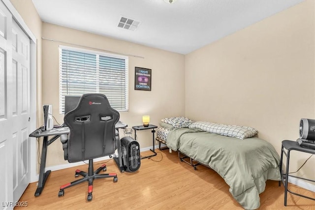 6068 Conroe Ct, Las Vegas, NV 89118 - bedroom with wood finished floors, a desk, and a closet