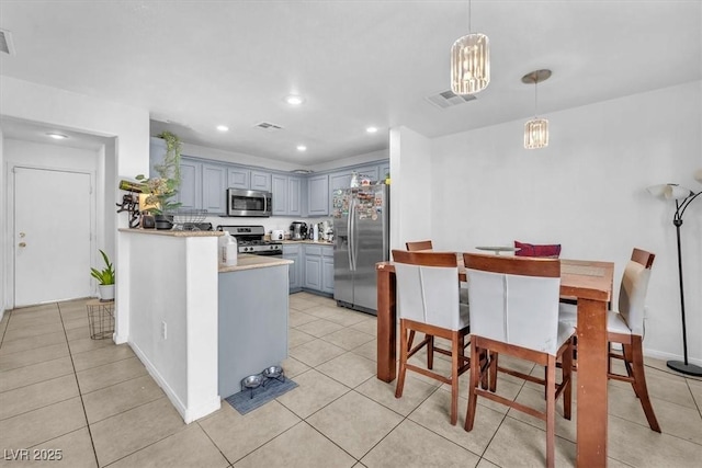 6068 Conroe Ct, Las Vegas, NV 89118 - kitchen with stainless steel appliances, gray cabinets, light countertops, recessed lighting, and light tile patterned floors