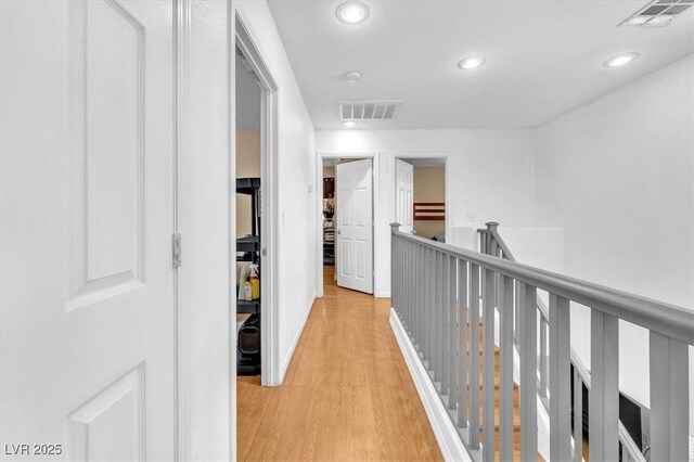 6068 Conroe Ct, Las Vegas, NV 89118 - corridor featuring light wood-style floors, recessed lighting, and an upstairs landing
