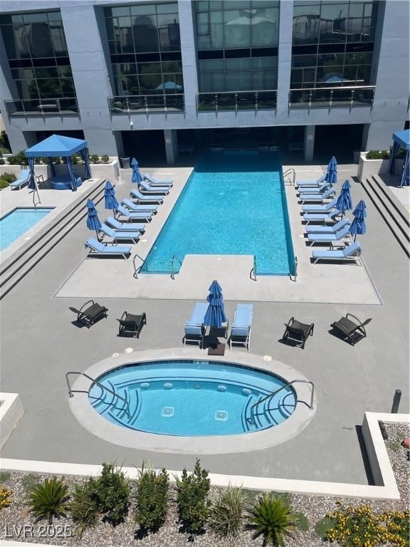8925 W Flamingo Rd Unit 105, Las Vegas, NV 89147 - community pool featuring a patio area and a hot tub