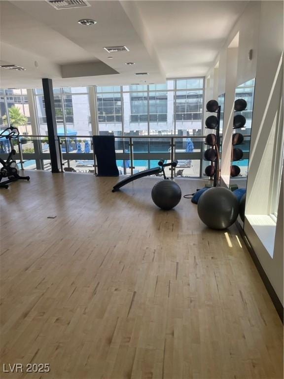 8925 W Flamingo Rd Unit 105, Las Vegas, NV 89147 - workout area with a wall of windows and wood finished floors