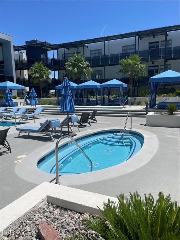 8925 W Flamingo Rd Unit 105, Las Vegas, NV 89147 - view of pool with a gazebo, a pool, a community hot tub, and a patio