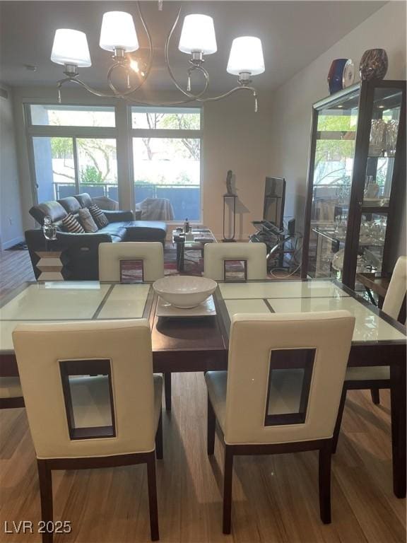 8925 W Flamingo Rd Unit 105, Las Vegas, NV 89147 - dining area with a chandelier and wood finished floors