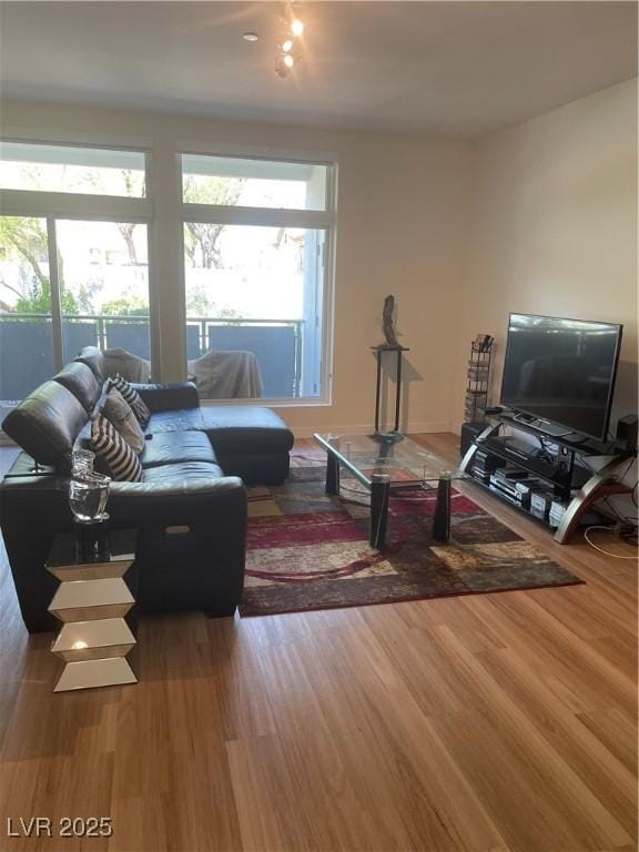 8925 W Flamingo Rd Unit 105, Las Vegas, NV 89147 - living room featuring wood finished floors and healthy amount of natural light