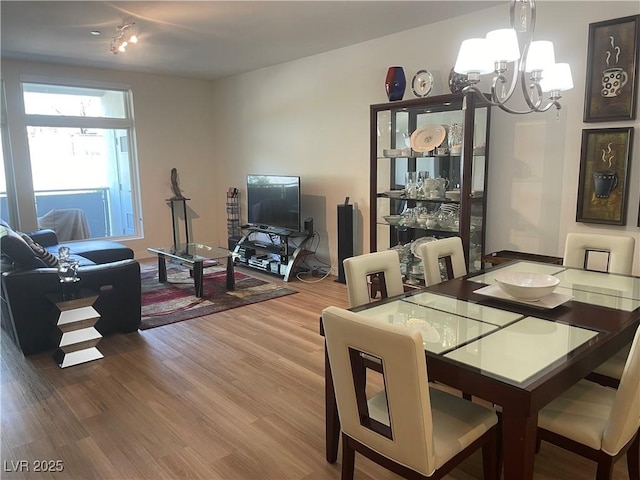 8925 W Flamingo Rd Unit 105, Las Vegas, NV 89147 - dining space featuring a chandelier and wood finished floors