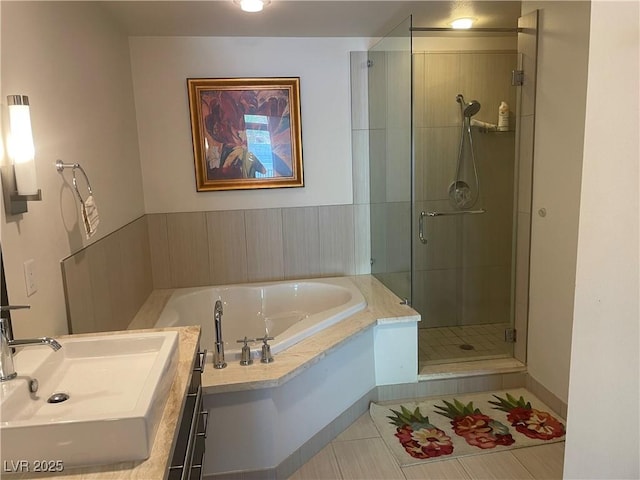 8925 W Flamingo Rd Unit 105, Las Vegas, NV 89147 - full bath with a shower stall, a garden tub, vanity, and tile patterned floors