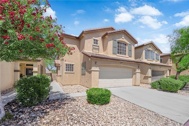 5653 Mount Athos St, North Las Vegas, NV 89031 - mediterranean / spanish house with stucco siding, a garage, driveway, and a tiled roof