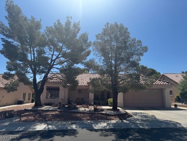 3104 Birch Grove Ct, Las Vegas, NV 89134 - view of front of house with a tile roof, concrete driveway, an attached garage, and stucco siding