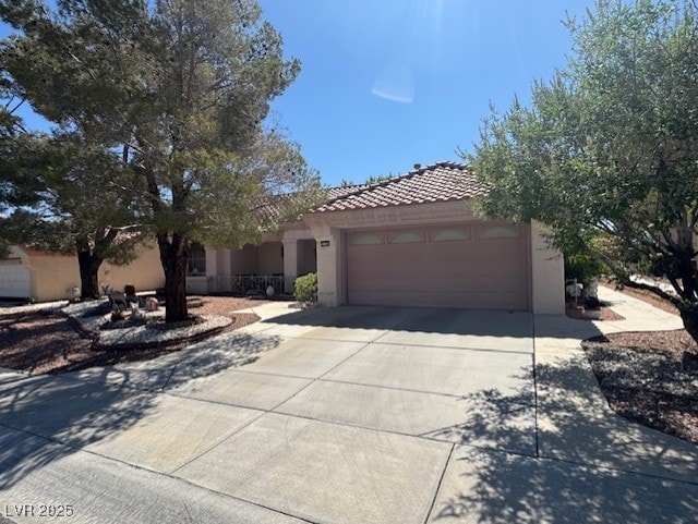 3104 Birch Grove Ct, Las Vegas, NV 89134 - view of front of property featuring stucco siding, a tile roof, concrete driveway, and a garage