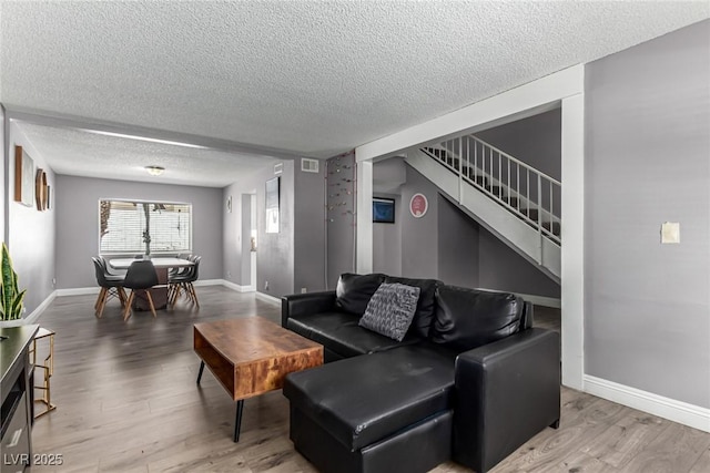 3158 Brockington Dr, Las Vegas, NV 89120 - living area featuring wood finished floors, stairway, and a textured ceiling