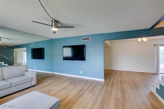 3785 Decade St, Las Vegas, NV 89121 - living room with wood finished floors, a textured ceiling, and a ceiling fan