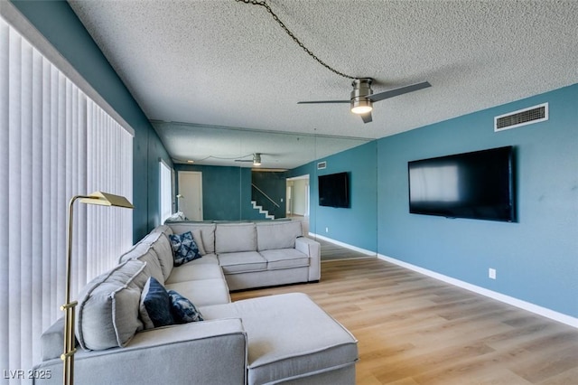 3785 Decade St, Las Vegas, NV 89121 - living room with a ceiling fan, light wood finished floors, and a textured ceiling