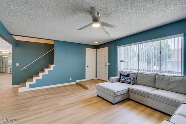 3785 Decade St, Las Vegas, NV 89121 - living room featuring a textured ceiling, a ceiling fan, wood finished floors, and stairway
