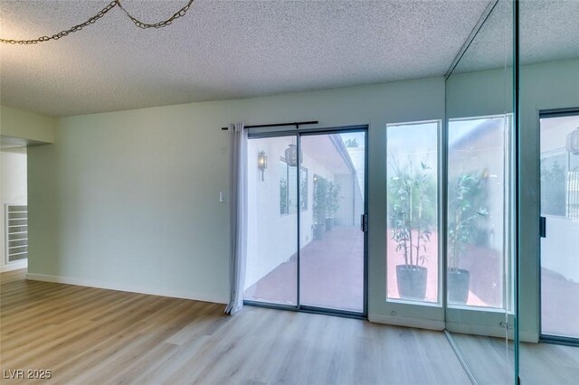 3785 Decade St, Las Vegas, NV 89121 - spare room with a textured ceiling and wood finished floors