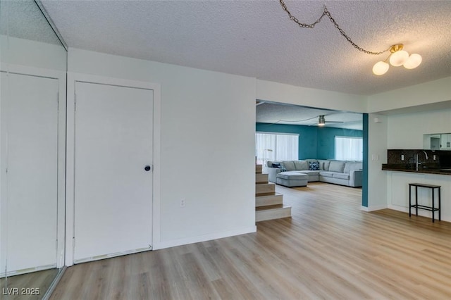3785 Decade St, Las Vegas, NV 89121 - living area featuring a textured ceiling, light wood finished floors, and a ceiling fan