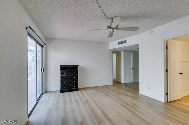 3785 Decade St, Las Vegas, NV 89121 - unfurnished living room featuring light wood-type flooring, a ceiling fan, and a textured ceiling