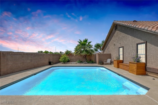 9015 S Tenaya Way, Las Vegas, NV 89113 - pool at dusk featuring a fenced backyard and a patio area