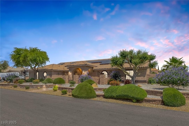 9015 S Tenaya Way, Las Vegas, NV 89113 - mediterranean / spanish-style home featuring roof mounted solar panels, stucco siding, and a tile roof