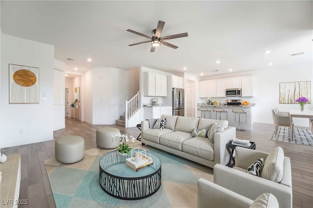 7124 Sayonara Vista St, North Las Vegas, NV 89084 - living area with stairs, light wood-type flooring, ceiling fan, and recessed lighting