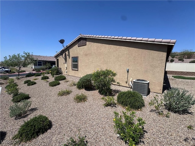 2653 Crystal Blue St, Laughlin, NV 89029 - view of side of home featuring stucco siding and a cooling unit