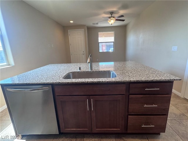 2653 Crystal Blue St, Laughlin, NV 89029 - kitchen featuring dishwasher, ceiling fan, light stone counters, dark brown cabinetry, and light tile patterned floors