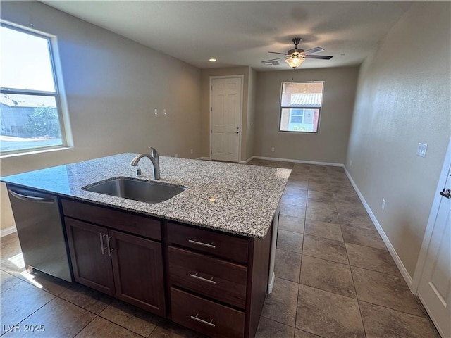 2653 Crystal Blue St, Laughlin, NV 89029 - kitchen featuring dishwasher, ceiling fan, an island with sink, light stone counters, and open floor plan