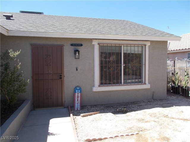 2211 Chipplegate Way N, Las Vegas, NV 89032 - doorway to property featuring a shingled roof and stucco siding