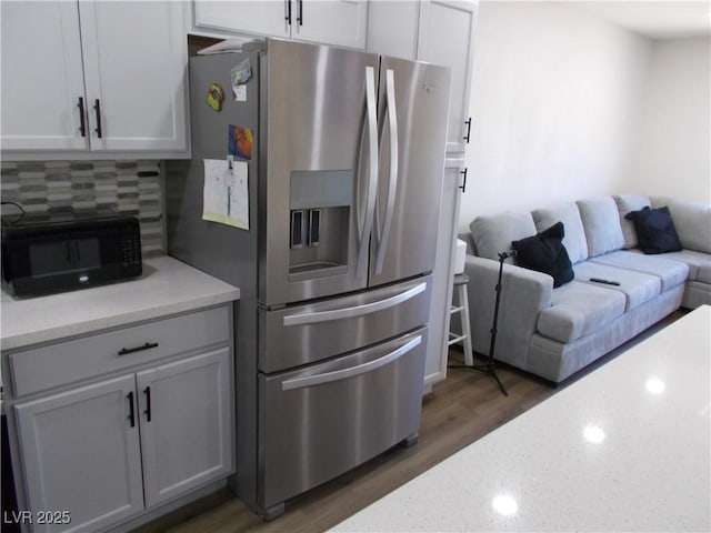 2211 Chipplegate Way N, Las Vegas, NV 89032 - kitchen featuring stainless steel refrigerator with ice dispenser, tasteful backsplash, wood finished floors, light stone countertops, and open floor plan